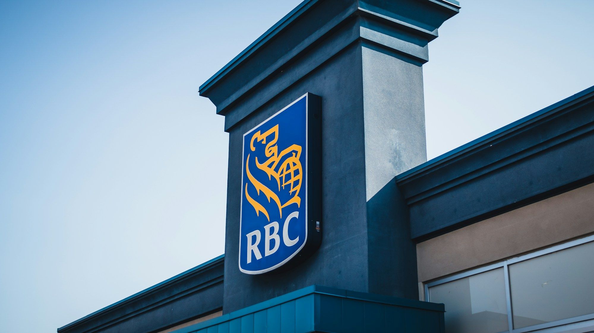 Blue and yellow RBC sign mounted on the side of a building