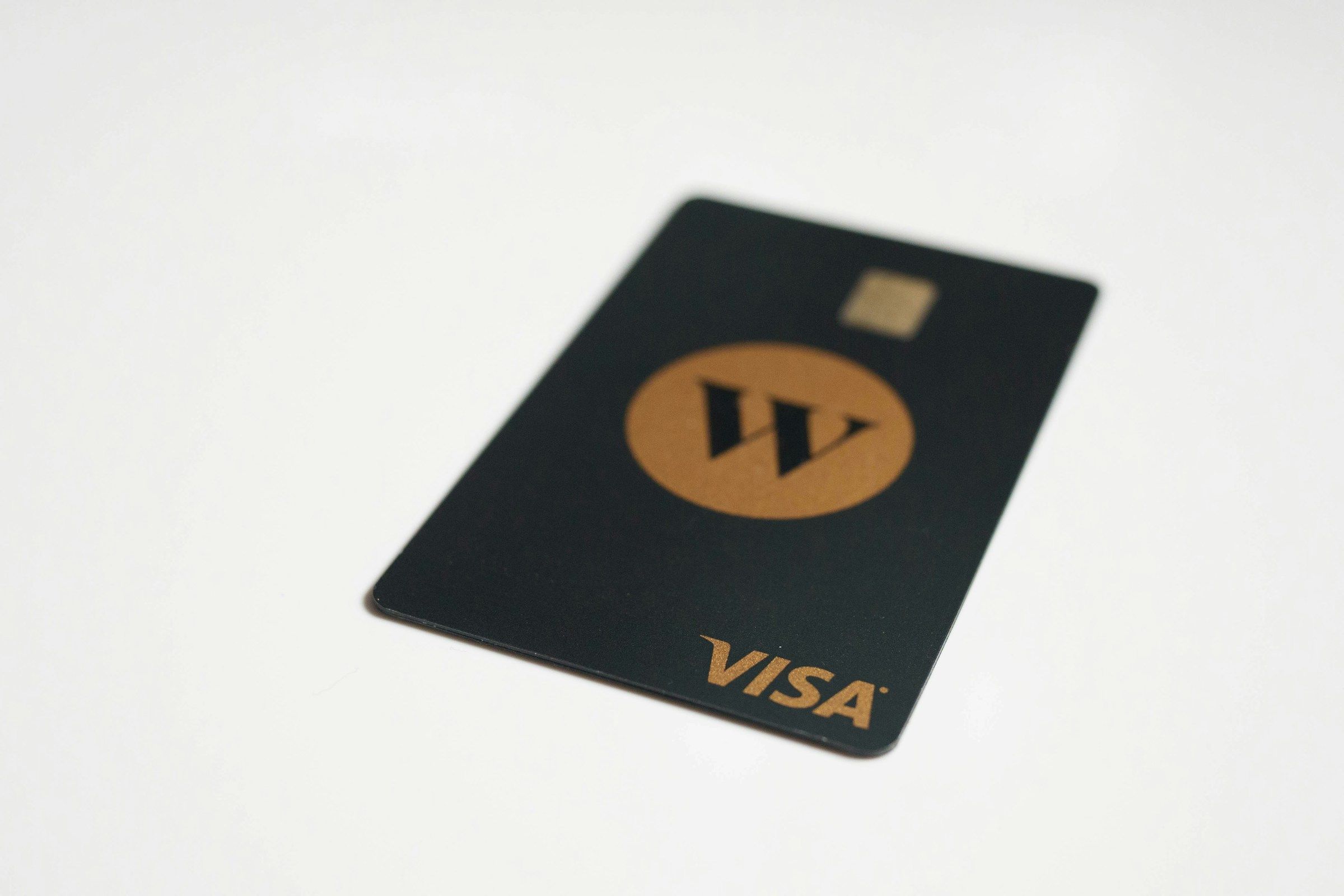 Black Wealthsimple Visa card resting on a white table.
