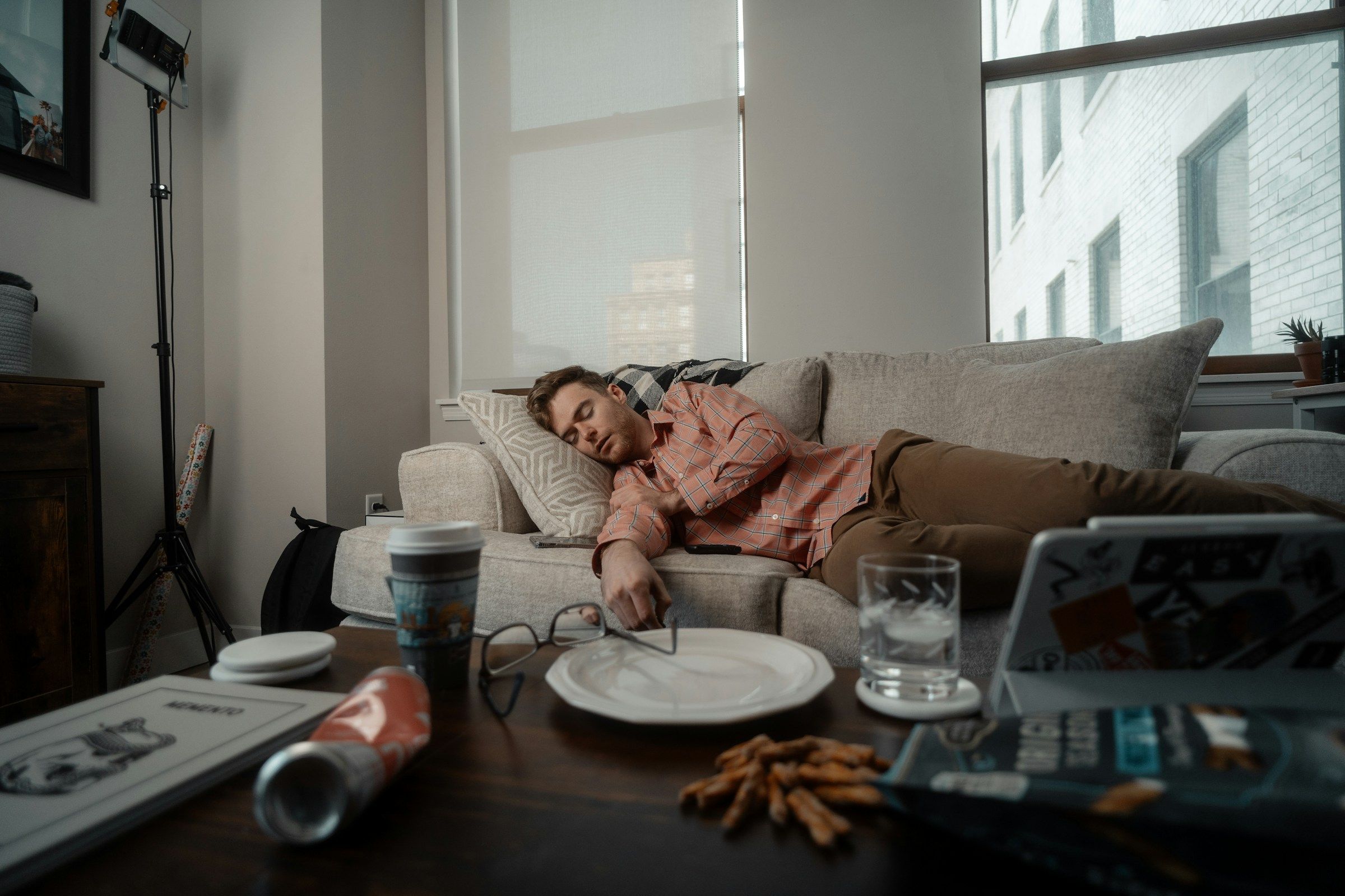 Woman reclining on a couch with a plate of food