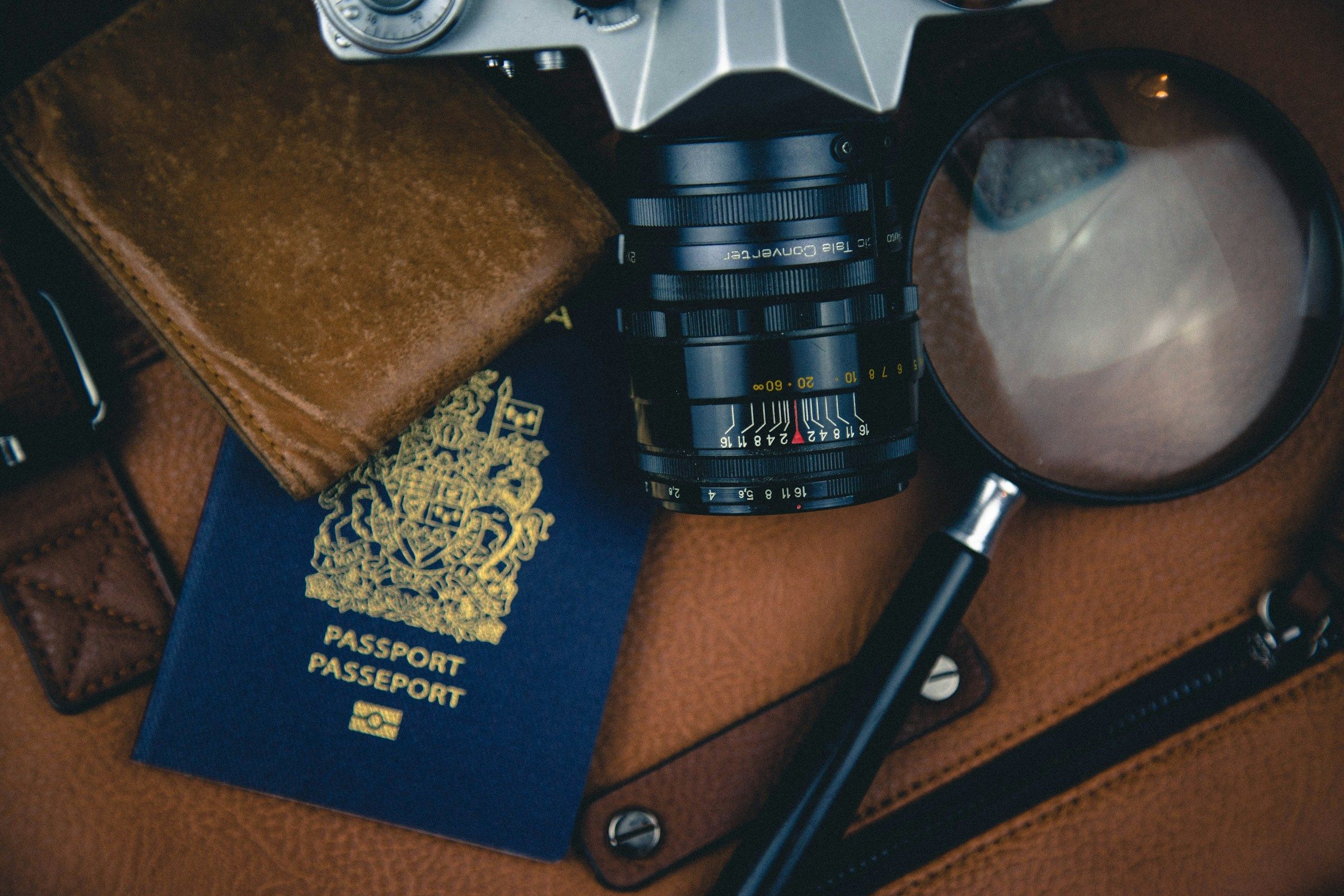 Black magnifying glass beside a camera lens